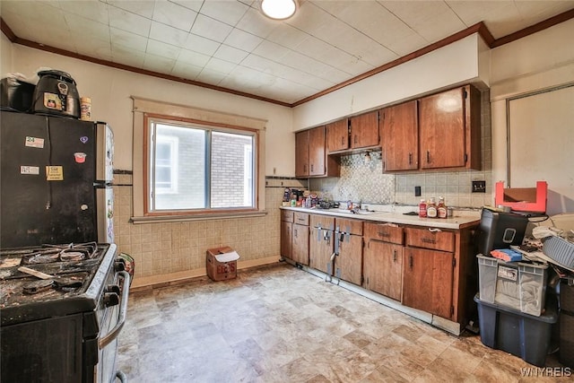 110 Saint Louis Ave, Buffalo, NY 14211 - kitchen featuring stainless steel appliances, crown molding, brown cabinets, light countertops, and a sink
