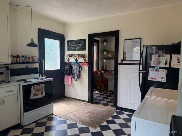 322 Eastern Ave, Herkimer, NY 13350 - kitchen featuring electric stove, light floors, washing machine and clothes dryer, and freestanding refrigerator