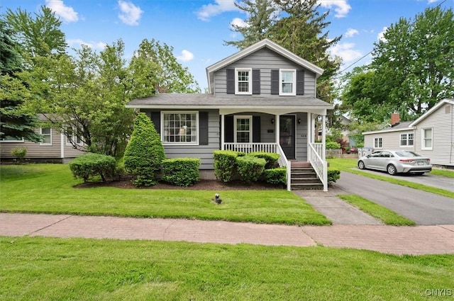 408 Elm St, Manlius, NY 13066 - view of front facade with a porch and a front yard