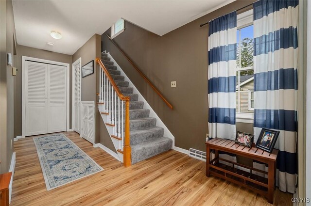 408 Elm St, Manlius, NY 13066 - foyer entrance featuring wood finished floors, baseboards, and stairway