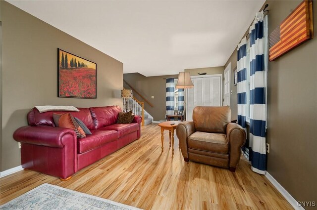 408 Elm St, Manlius, NY 13066 - living area featuring wood finished floors, stairway, and baseboards