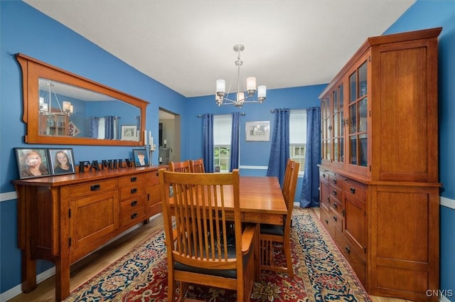 408 Elm St, Manlius, NY 13066 - dining area featuring a chandelier, light wood finished floors, and baseboards