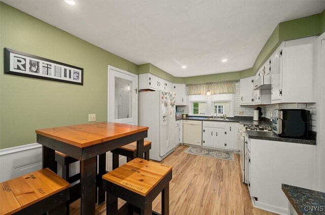 408 Elm St, Manlius, NY 13066 - kitchen featuring white appliances, white cabinetry, dark countertops, a sink, and recessed lighting