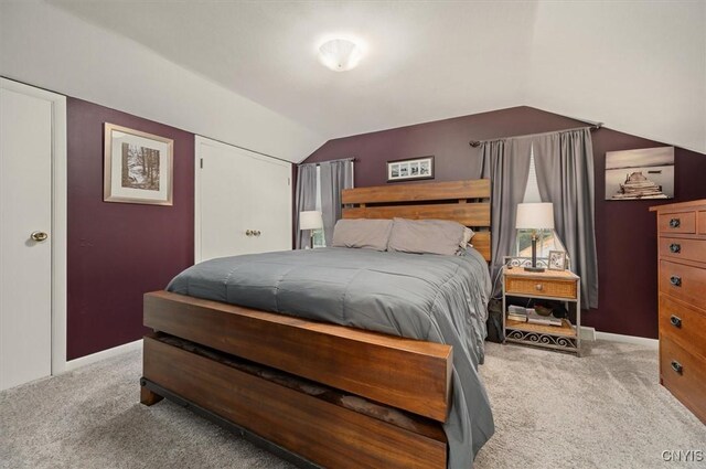 408 Elm St, Manlius, NY 13066 - bedroom with light colored carpet, lofted ceiling, and baseboards