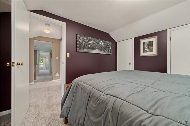 408 Elm St, Manlius, NY 13066 - bedroom with vaulted ceiling, carpet floors, and baseboards