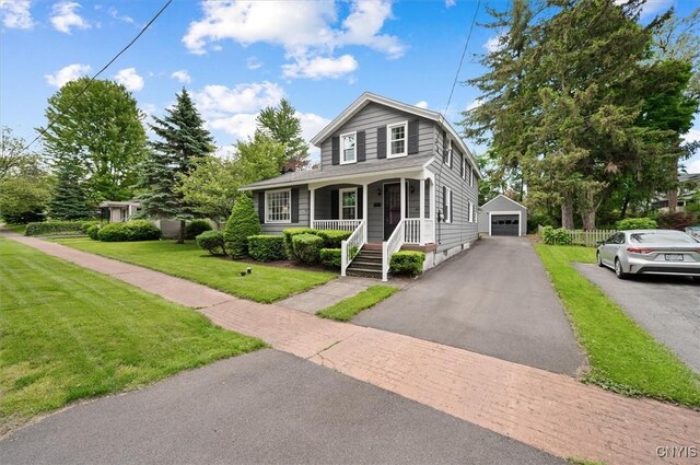 408 Elm St, Manlius, NY 13066 - view of front of home with covered porch, an outbuilding, a garage, a front yard, and driveway