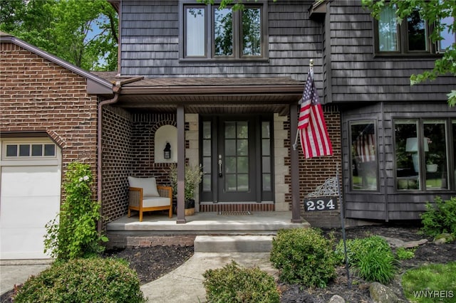 234 Misty Ln, Amherst, NY 14051 - doorway to property with a porch, brick siding, and a garage
