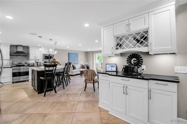 234 Misty Ln, Amherst, NY 14051 - kitchen featuring stainless steel appliances, wall chimney range hood, light tile patterned floors, recessed lighting, and white cabinetry