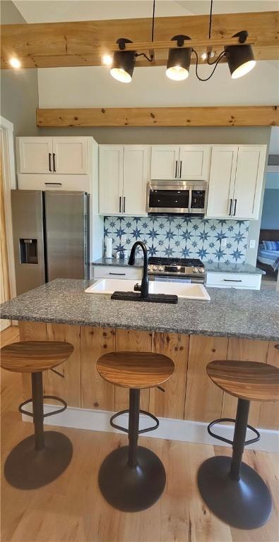 2185 Hog Mountain Rd, Middletown, NY 12455 - kitchen featuring stainless steel appliances, white cabinets, dark stone countertops, and decorative backsplash