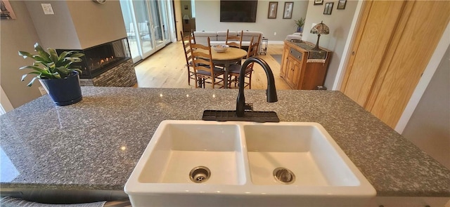 2185 Hog Mountain Rd, Middletown, NY 12455 - detailed view of a sink, wood finished floors, and a multi sided fireplace