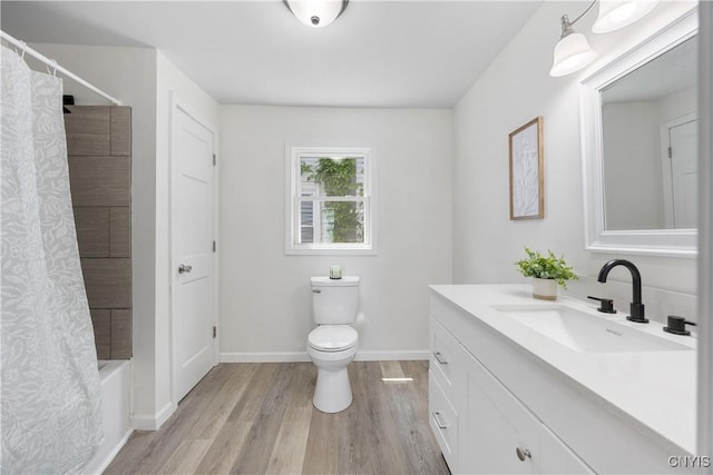 220 W Elm St, Oneida-Inside, NY 13421 - bathroom with vanity, wood finished floors, toilet, shower / tub combo with curtain, and baseboards