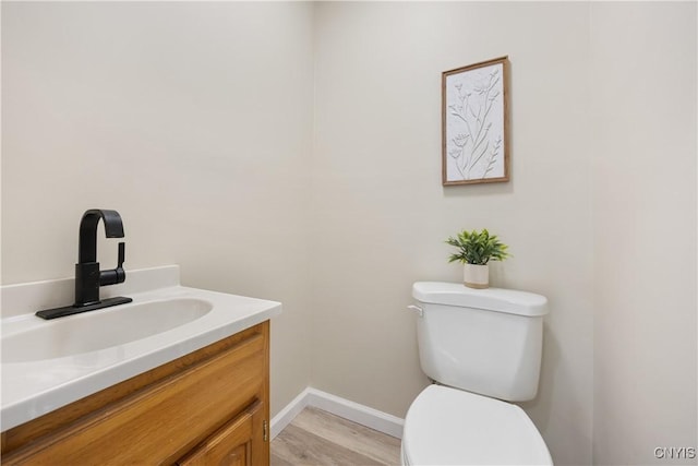 220 W Elm St, Oneida-Inside, NY 13421 - bathroom with toilet, vanity, and baseboards