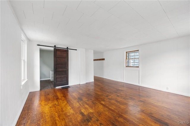 220 W Elm St, Oneida-Inside, NY 13421 - spare room featuring a barn door and wood finished floors
