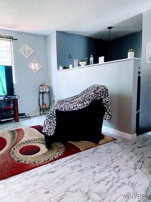 6954 Academy Ln, Lockport-Town, NY 14094 - living area featuring a textured ceiling and marble look tiles
