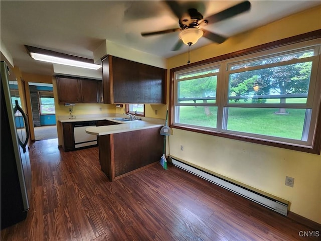 6 Heather Woods Ct, Skaneateles, NY 13152 - kitchen with a baseboard radiator, freestanding refrigerator, a peninsula, dishwasher, and light countertops