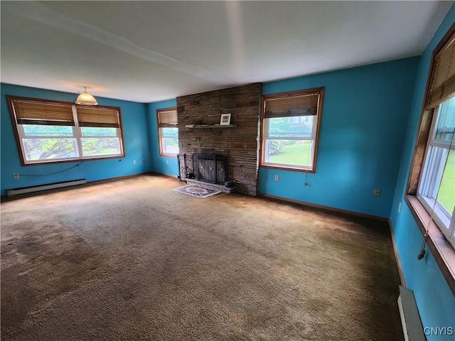 6 Heather Woods Ct, Skaneateles, NY 13152 - unfurnished living room featuring baseboard heating, carpet floors, and a fireplace