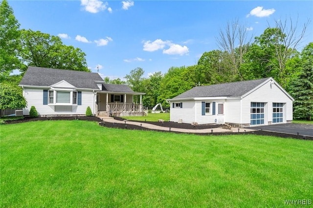 2350 Quaker Rd, Hartland, NY 14067 - view of front of property featuring a porch, an outbuilding, a garage, a front lawn, and a shingled roof
