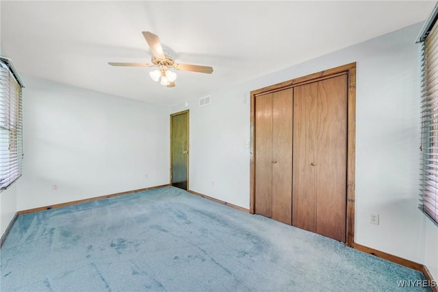 2350 Quaker Rd, Hartland, NY 14067 - unfurnished bedroom with baseboards, carpet, a ceiling fan, and a closet