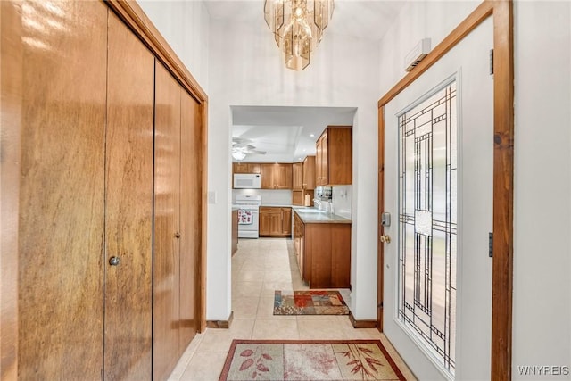 2350 Quaker Rd, Hartland, NY 14067 - foyer with light tile patterned floors, baseboards, and a chandelier