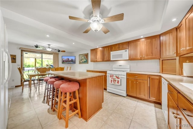 2350 Quaker Rd, Hartland, NY 14067 - kitchen with white appliances, a breakfast bar, light tile patterned floors, light countertops, and recessed lighting