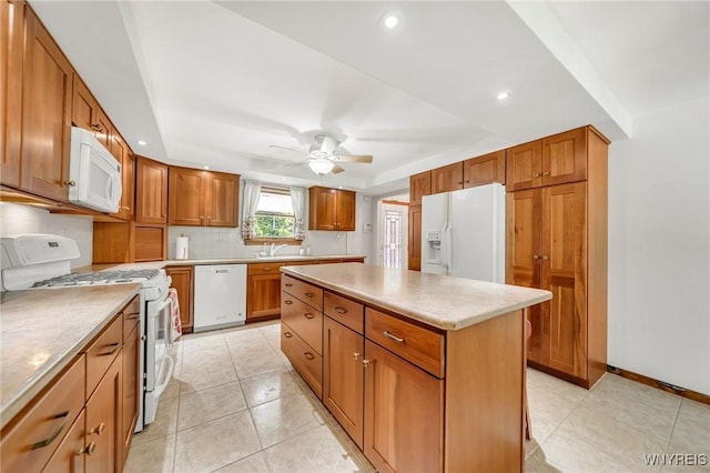 2350 Quaker Rd, Hartland, NY 14067 - kitchen featuring white appliances, a kitchen island, decorative backsplash, brown cabinetry, and a ceiling fan
