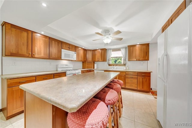 2350 Quaker Rd, Hartland, NY 14067 - kitchen featuring white appliances, a tray ceiling, light countertops, and recessed lighting