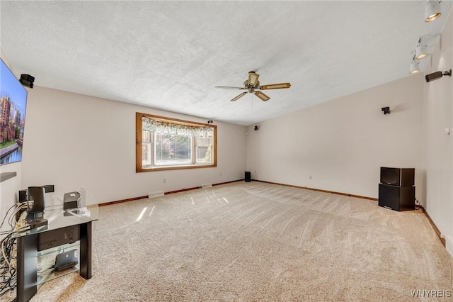 2350 Quaker Rd, Hartland, NY 14067 - unfurnished living room featuring ceiling fan, carpet, baseboards, and a textured ceiling