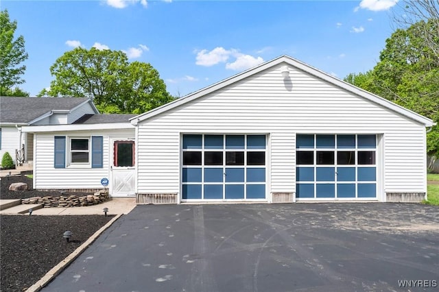 2350 Quaker Rd, Hartland, NY 14067 - view of front of home featuring a garage, driveway, and roof with shingles