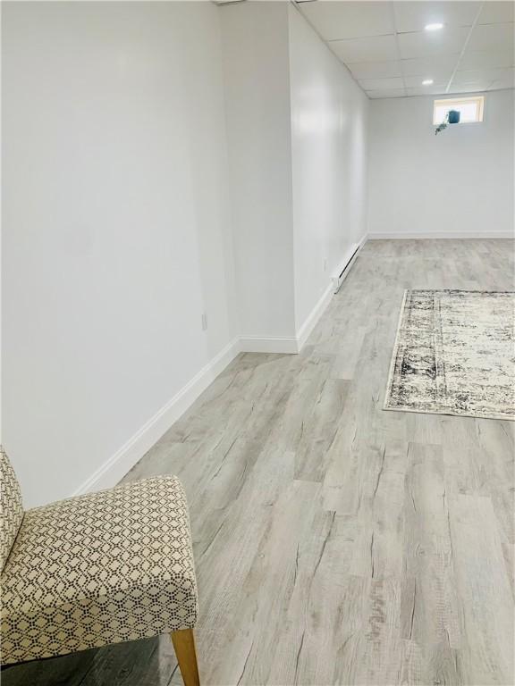 438 Hillview Ave, Southport, NY 14904 - spare room featuring baseboard heating, wood finished floors, and baseboards
