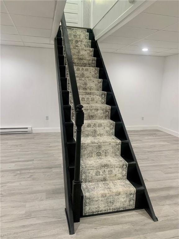 438 Hillview Ave, Southport, NY 14904 - staircase with a baseboard heating unit, wood finished floors, a drop ceiling, and recessed lighting
