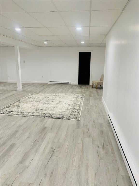 438 Hillview Ave, Southport, NY 14904 - finished below grade area with baseboard heating, a baseboard heating unit, light wood-type flooring, a drop ceiling, and recessed lighting