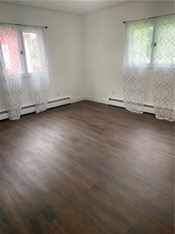 438 Hillview Ave, Southport, NY 14904 - spare room featuring dark wood-style floors, baseboards, and a baseboard heating unit