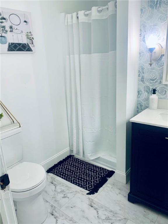 438 Hillview Ave, Southport, NY 14904 - full bathroom featuring marble look tile flooring, vanity, toilet, a shower with shower curtain, and baseboards