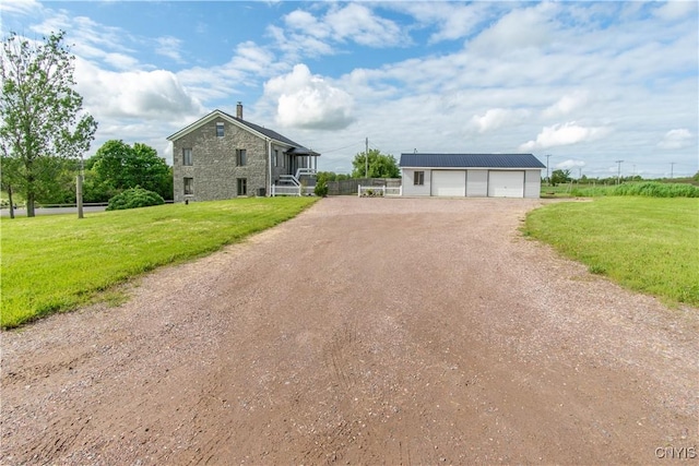 24401 Cheever Rd, Pamelia, NY 13601 - view of front of house with an outbuilding, a detached garage, a front lawn, and driveway