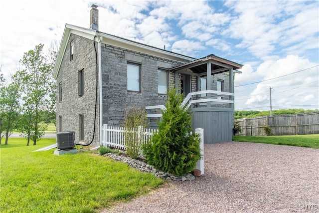 24401 Cheever Rd, Pamelia, NY 13601 - view of front of home with stone siding, cooling unit, and a chimney