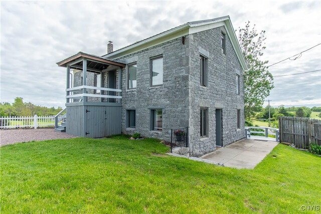 24401 Cheever Rd, Pamelia, NY 13601 - back of house featuring stone siding and a chimney