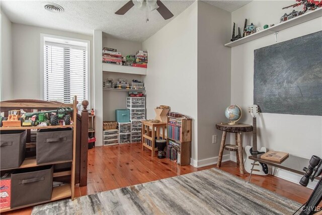 24401 Cheever Rd, Pamelia, NY 13601 - office area with wood finished floors, a ceiling fan, and a textured ceiling