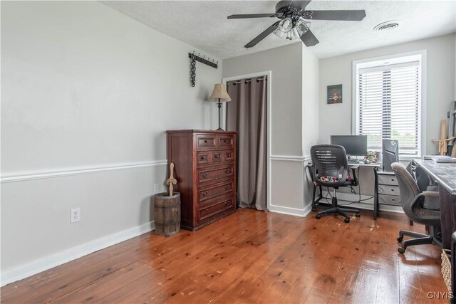 24401 Cheever Rd, Pamelia, NY 13601 - office space featuring hardwood / wood-style floors, a ceiling fan, baseboards, and a textured ceiling