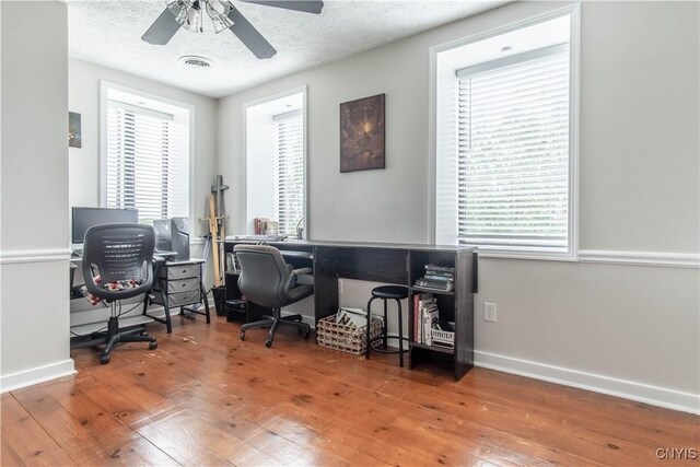 24401 Cheever Rd, Pamelia, NY 13601 - office area with hardwood / wood-style floors, baseboards, ceiling fan, plenty of natural light, and a textured ceiling