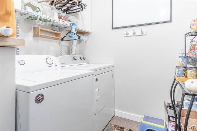 24401 Cheever Rd, Pamelia, NY 13601 - laundry room featuring washing machine and dryer, baseboards, and wood finished floors