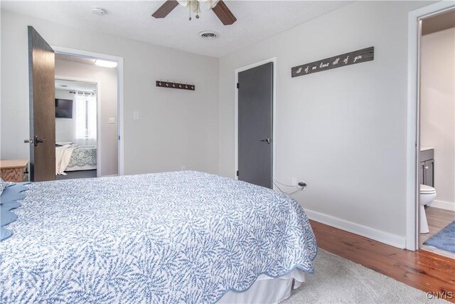 24401 Cheever Rd, Pamelia, NY 13601 - bedroom with wood finished floors, baseboards, connected bathroom, and ceiling fan