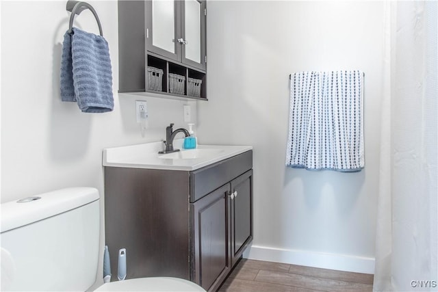 24401 Cheever Rd, Pamelia, NY 13601 - full bathroom with toilet, wood finished floors, vanity, and baseboards