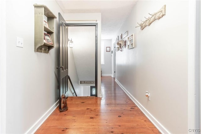 24401 Cheever Rd, Pamelia, NY 13601 - corridor featuring an upstairs landing, light wood finished floors, and baseboards