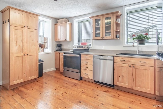 24401 Cheever Rd, Pamelia, NY 13601 - kitchen featuring appliances with stainless steel finishes, light brown cabinets, and a textured ceiling