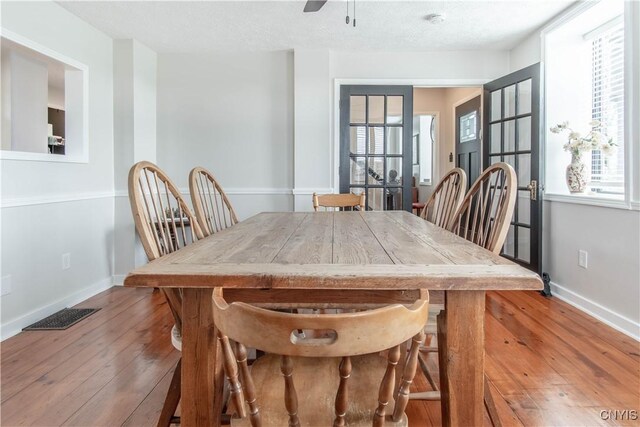 24401 Cheever Rd, Pamelia, NY 13601 - dining space featuring hardwood / wood-style flooring, healthy amount of natural light, baseboards, and a ceiling fan