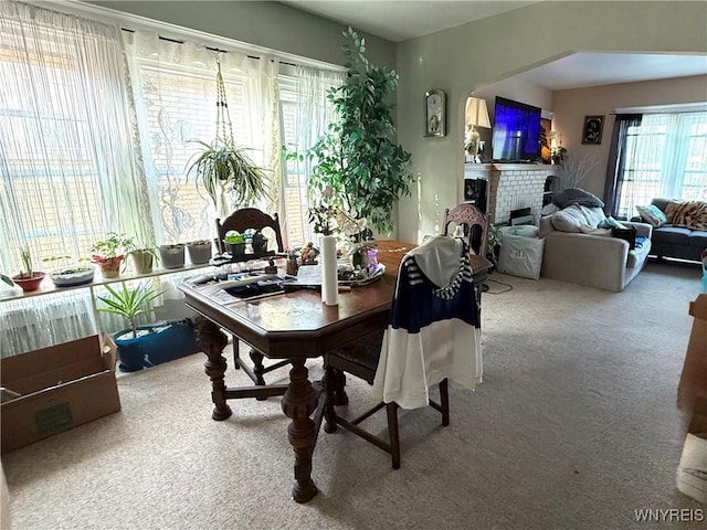 46 Cunard Rd, Buffalo, NY 14216 - dining room featuring carpet flooring, a brick fireplace, and arched walkways