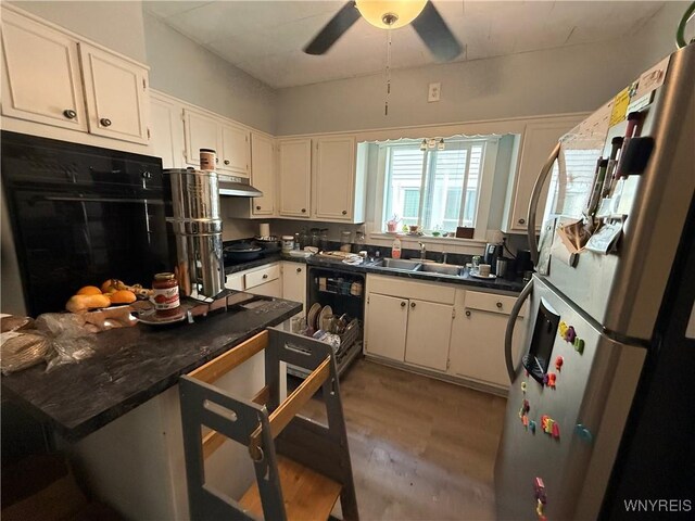 46 Cunard Rd, Buffalo, NY 14216 - kitchen featuring a sink, black appliances, light wood finished floors, dark countertops, and ceiling fan