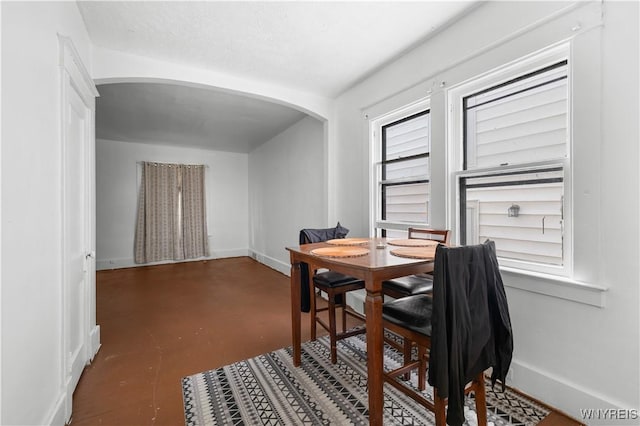 204 Crowley Ave, Buffalo, NY 14207 - dining area featuring arched walkways, concrete floors, and baseboards