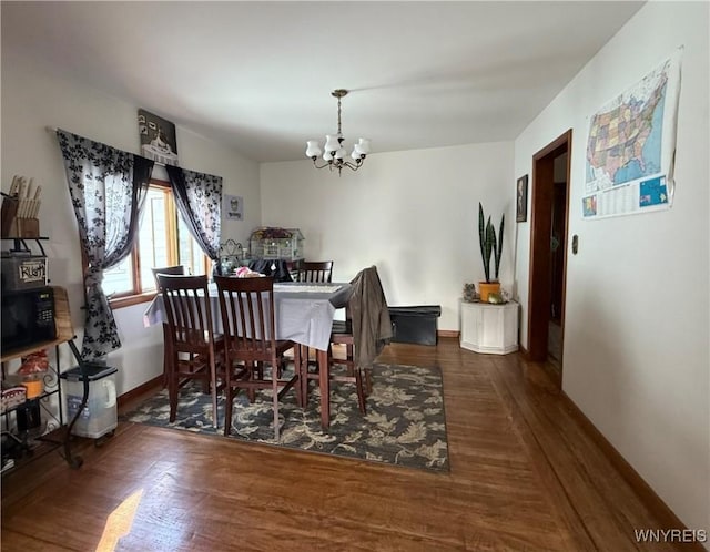 189 Lovering Ave, Buffalo, NY 14216 - dining area featuring a chandelier, wood finished floors, and baseboards