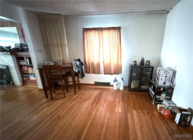 189 Lovering Ave, Buffalo, NY 14216 - dining area featuring wood finished floors and a stone fireplace